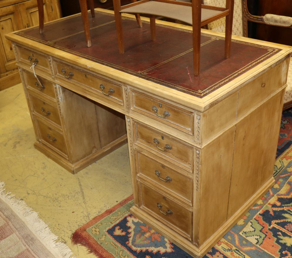 An early 20th century pine pedestal desk, W.130cm, D.63cm, H.73cm